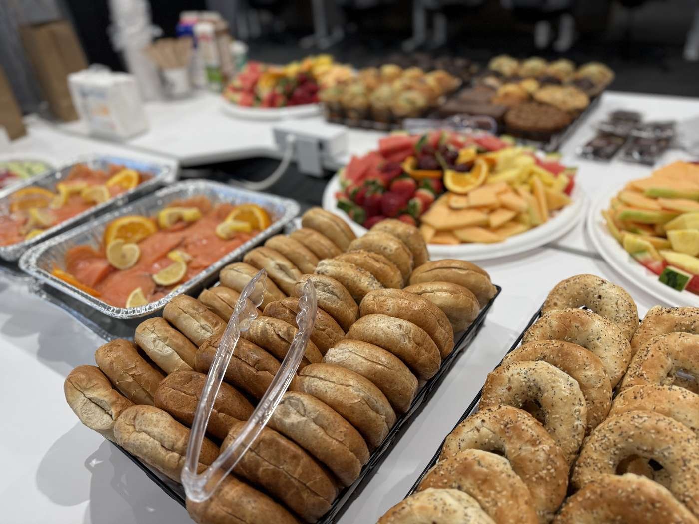 Long buffet table of hot and cold catering trays laid out for an event