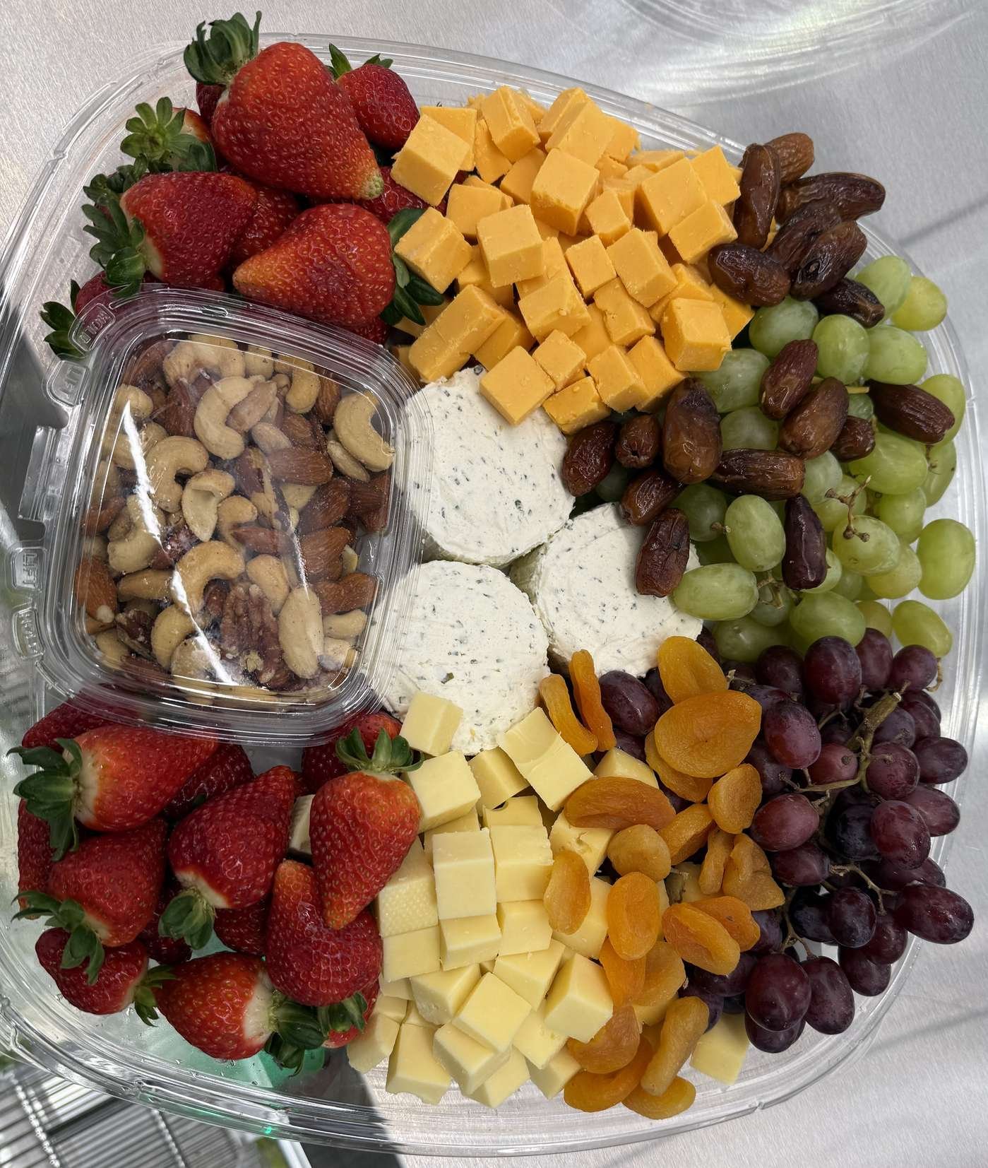 Cheese and fruit board with strawberries and grapes