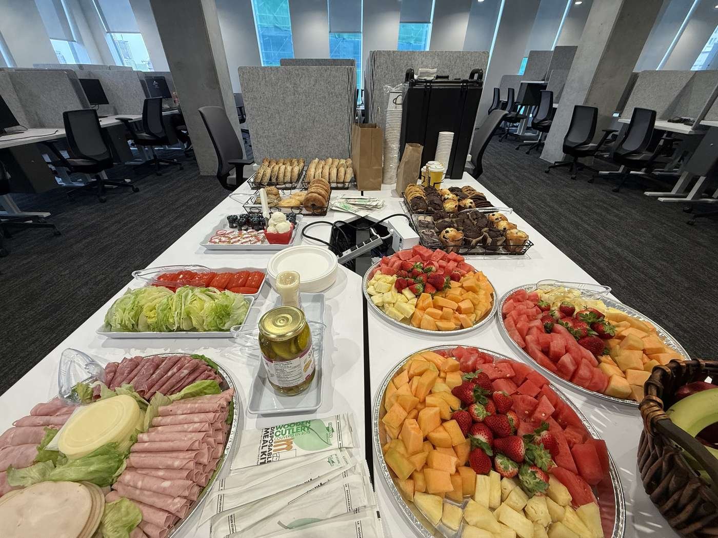 Event table laid with fruit, pastries and savoury platters