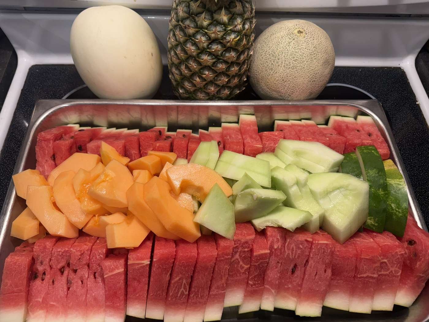 Fresh fruit tray with sliced watermelon, melon and pineapple