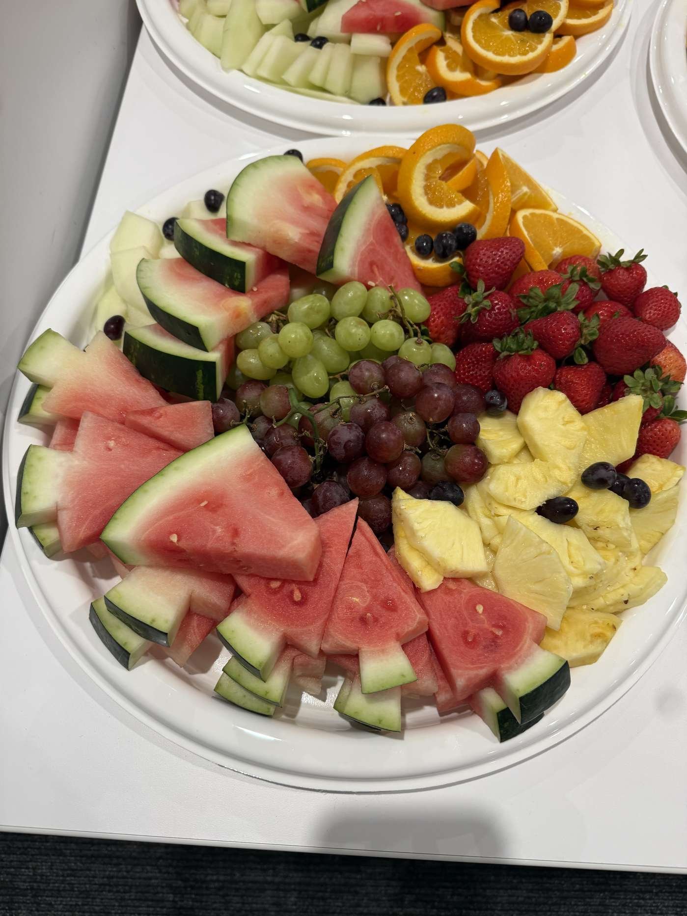 Seasonal fruit platter with watermelon, melon, grapes and berries